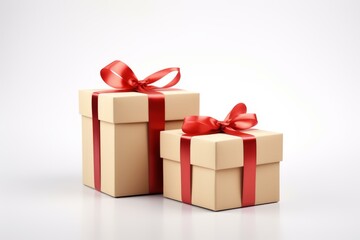 Obraz premium Two gift boxes with red ribbons are waiting to be opened for a special occasion