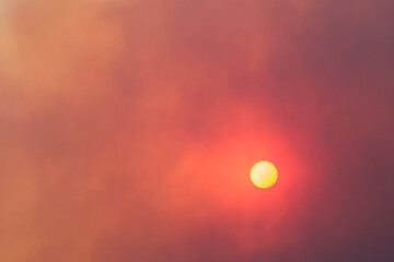 sun shining through a smoke-filled sky