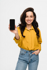 Fototapeta premium Smiling young woman girl female student holding using smart cell mobile phone showing demonstrate