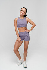 Full body young strong sporty woman athletic fitness trainer instructor coach wear pastel tracksuit...