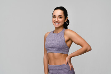 Young strong sporty woman athletic fitness trainer instructor coach wear pastel tracksuit spend time in home gym hold hands on waist isolated on white background copy space. Workout sport concept