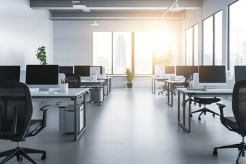 Modern open plan office interior with desks, computers and large windows. Bright workspace with sunlight. Corporate environment for business and teamwork