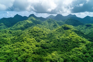 Lush, verdant landscape of tropical mountains under a dramatic sky captures the essence of nature's beauty in a remote paradise