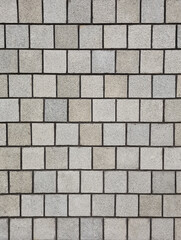 Background of multi grey square granite tile wall. Rough surface textured granite square tile wall for decoration.
