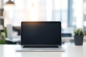 Fototapeta premium Open laptop on desk with plant. Modern office workspace. Clean minimalist setup for remote work, business, or study. Bright interior with window view. Copy space on screen