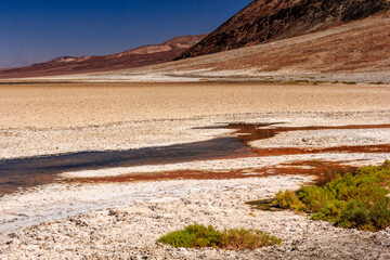 A desert landscape with a river running through it
