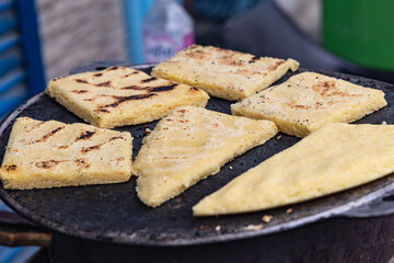 Beja, Tunisia. Flat bread being grilled at an outdoor market.