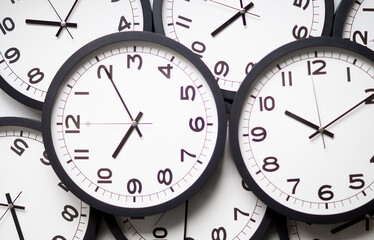 Close-Up of Multiple Black and White Analog Clocks Overlapping Each Other