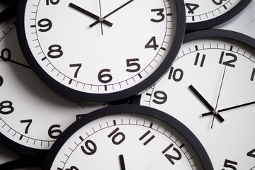 Close-Up of Multiple Black and White Analog Clocks Overlapping Each Other