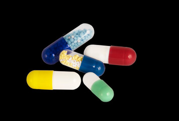 medical pills on black background close up