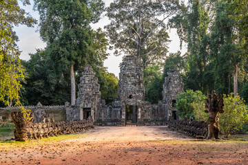 Fototapeta premium Ancient hindu Preah Khan khmer ruined temple gopura gate with statues hidden in jungles, Angkor Archaeological Park, Siem Reap, Cambodia