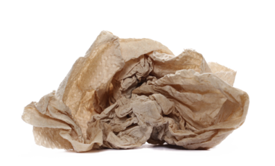 Natural brown paper towel scrap, non-toxic and no dyes, crumpled and wrinkled ball isolated on white