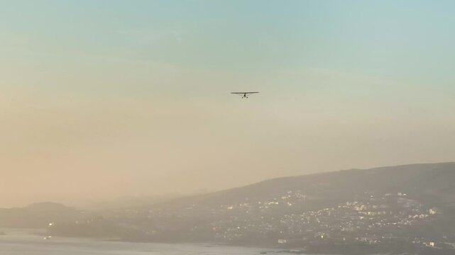 Aircraft cessna in flight over the coast