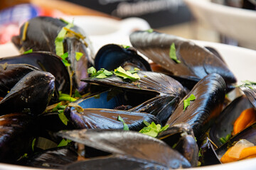 Steamed mussels served in a bowl  garnished with fresh parsley