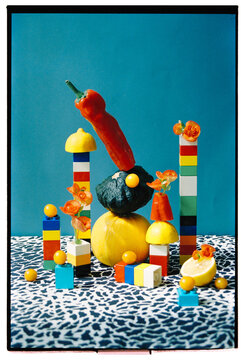 Fruits stacked creatively with multicolored blocks