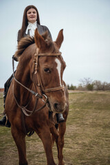Fototapeta premium A person riding a horse in a field