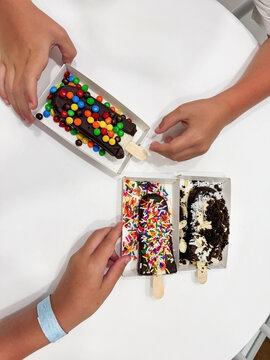 UGC - Hand Holding Colorful Paleta with Candy Toppings