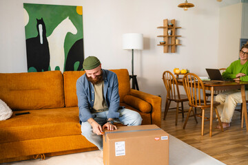 A man unpacks a parcel