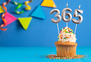 Three candles forming the number 365 - Blue background.