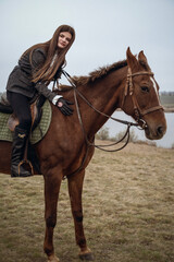 Fototapeta premium A person riding a horse in a field