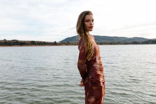 Model near lake in autumn