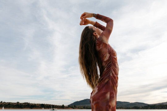 Woman bending backwards with folded arms