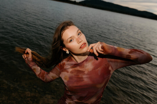 Sensual model touching chin in dusk