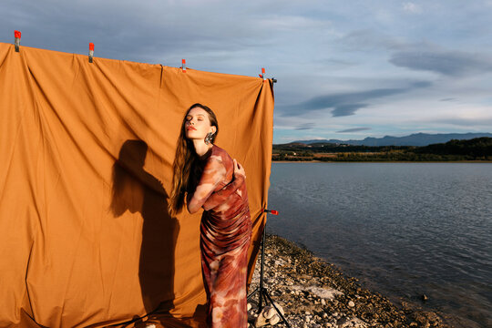 Model near backdrop on lakeside