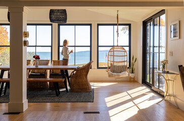 Luxury Coastal home woman drinking morning coffee 