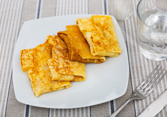 Delicious pancakes stuffed with liver and egg served on platter for breakfast