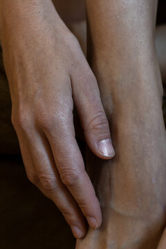 Hand Touching Leg Close-Up