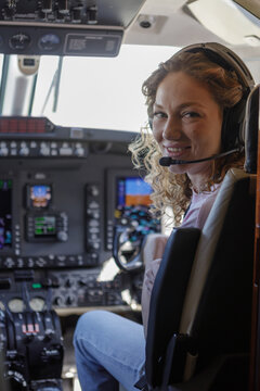 A girl in the cockpit of an airplane 