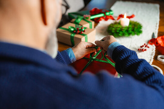 A man is packing Christmas presents