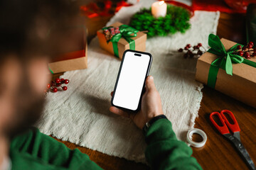 A man uses a mobile phone with white screen for Christmas