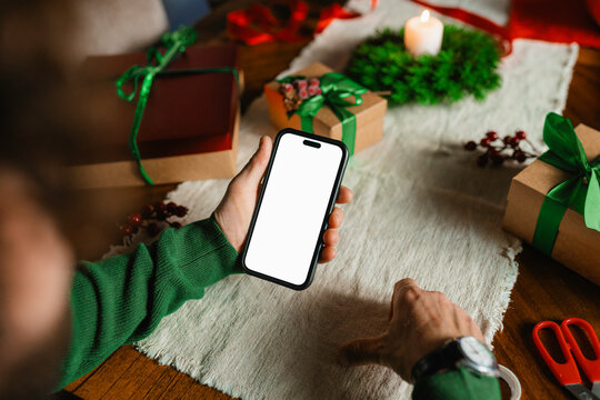 A man uses a mobile phone with white screen for Christmas