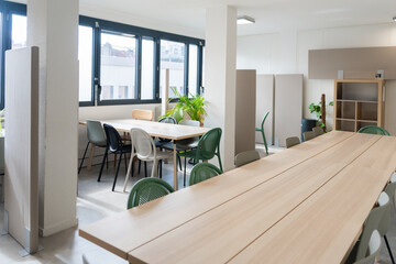 Bright Office Workspace With Shared Tables and Chairs

