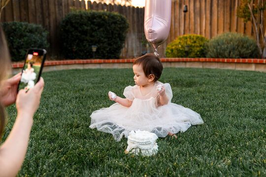 mom taking cellphone picture of baby
