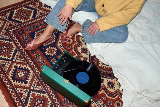 Woman listening vinyl player