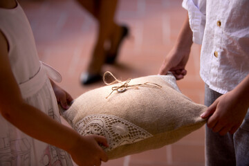 kids holding rustic wedding ring pillow
