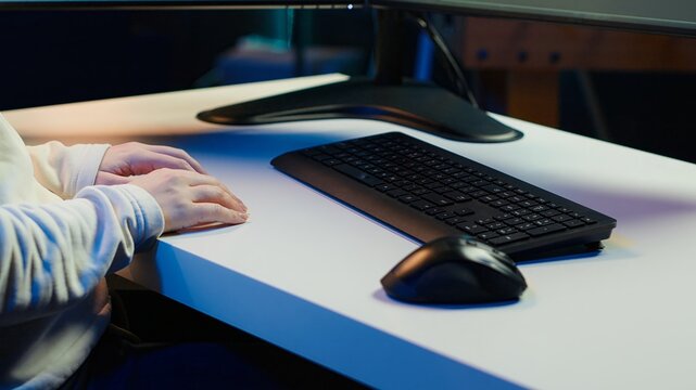 Teleworking computer technician typing on keyboard, implementing security measures to protect company systems and data, close up. Remote IT employee at home debugging code for software, camera A