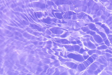 Pink water bubbles on the surface ripples. Defocus blurred transparent pink colored clear calm water surface texture with splash and bubbles. Water waves with shining pattern texture background