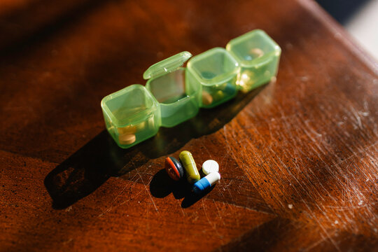 Pills in a pillbox on the table