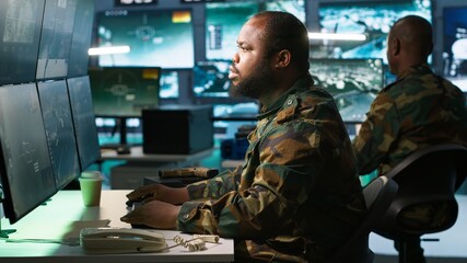Intelligence corps expert in military HQ base gathering information on enemy troops. Officer...