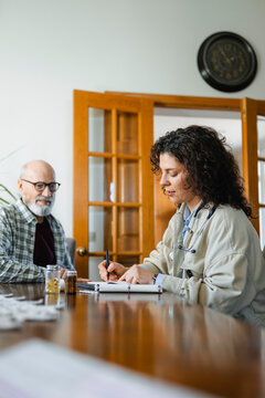 The doctor talks to the patient at home