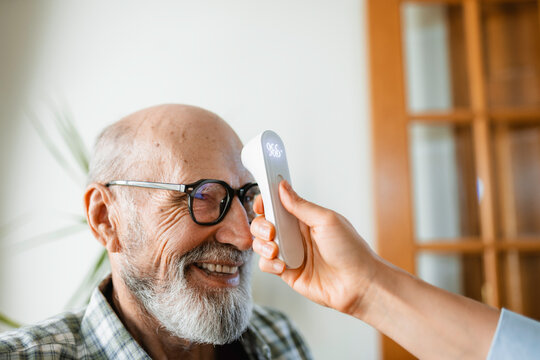 The doctor measures the patient's temperature