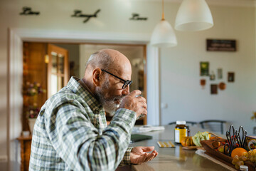 The man is going to take a pill