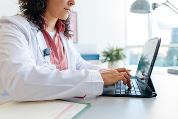 The doctor uses a tablet in the clinic