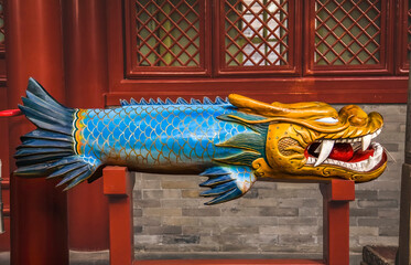 Old Wooden Dragon Fish Bell Fayuan Buddhist Temple, Beijing, China. This wooden bell is used to...
