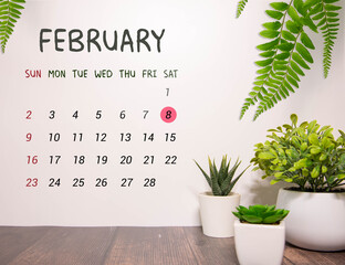 Cube shape calendar for February 8 on wooden surface with empty space for text