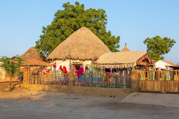 India, State of Gujarat, Bhuj, Meghwal. Bhirandiara. Village house, clothing drying on fence.